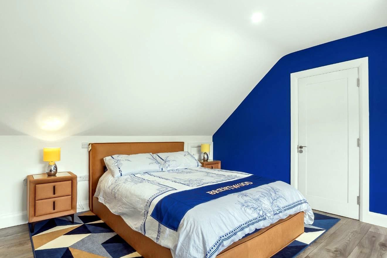 Bedroom with navy feature wall