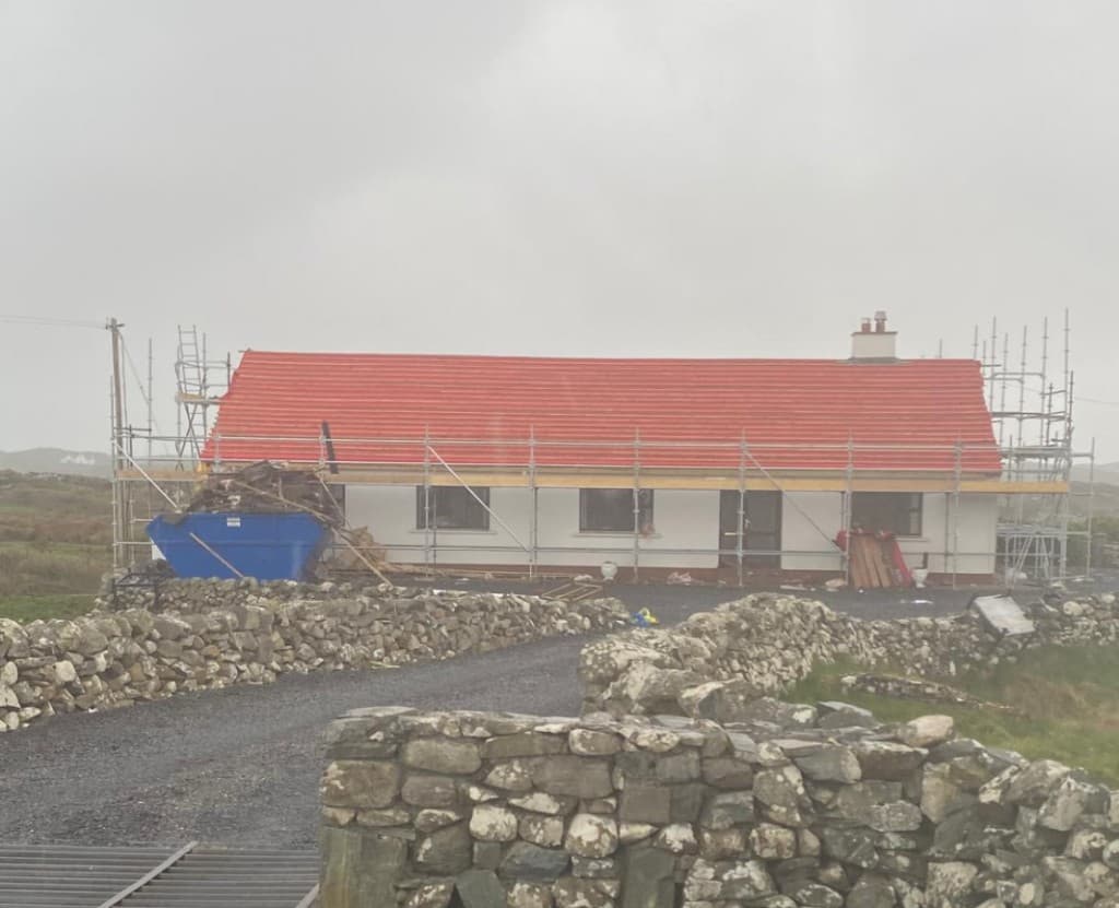 Before works — existing roof under scaffold with new covering