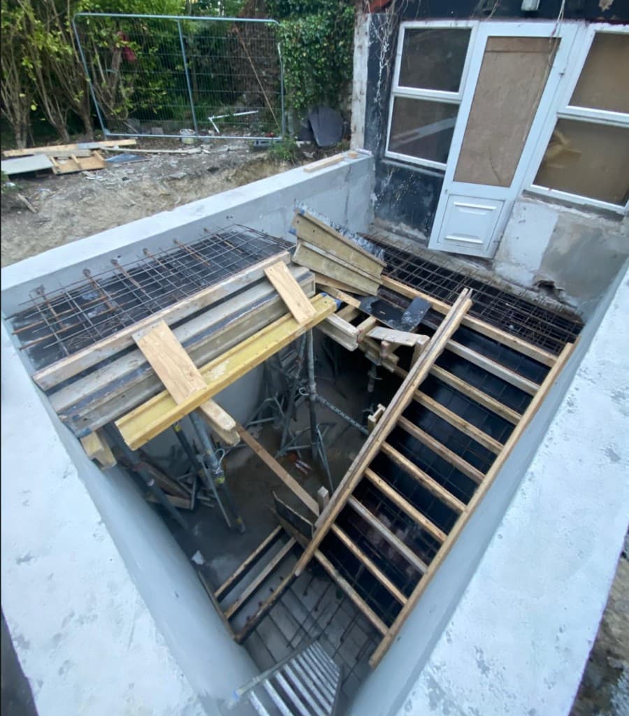Basement opening and formwork setup at active build stage